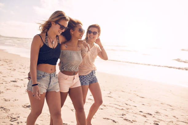 istock Young friends walking along a beach during summertime 515076660