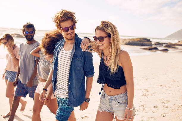 istock Happy friends having a walk on the beach 515076772
