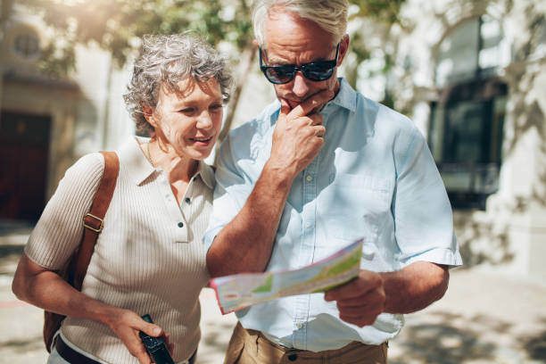 istock Middle aged couple looking at city map 515078702