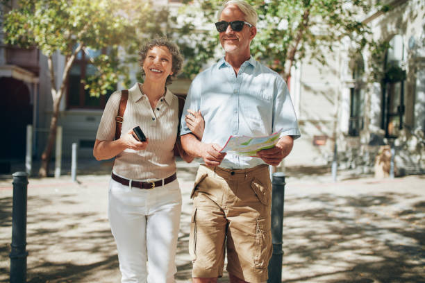 istock Senior couple walking around the city holding a map 515078840