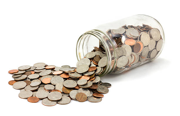 istock Jar of Coins Spilled on White Background 515079096