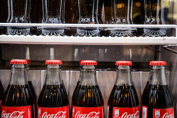 A large group of Coca-Cola red cans stacked in a supermarket in Spain.
