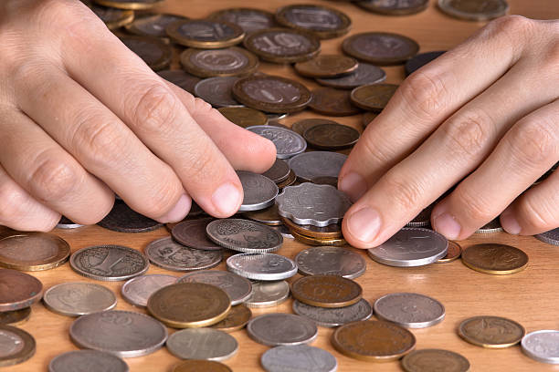 istock hands with heap of coins 515080732