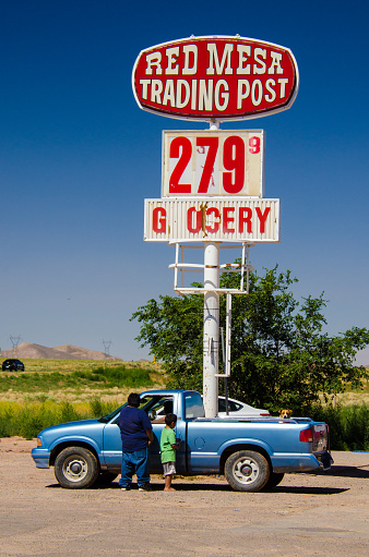 Red Mesa, Arizona, USA - August 6, 2015: Navajo people stand by their car at Red Mesa Trading Post and Gas Station, Arizona