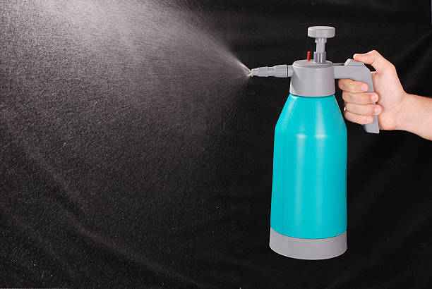 istock Male hand holding spray bottle 515083352