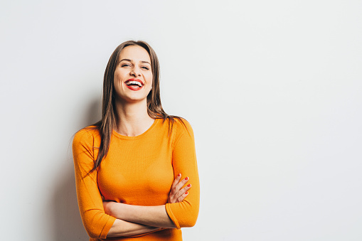 Young girl posing in front of a white background.