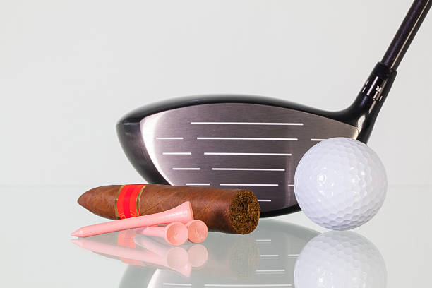istock Golf driver and different cigars on a glass desk 515084836