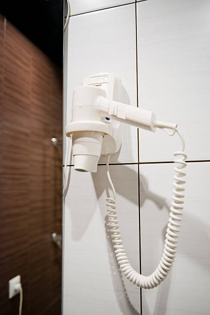 istock White Hair Dryer on wall in bathroom. SPA 515141539