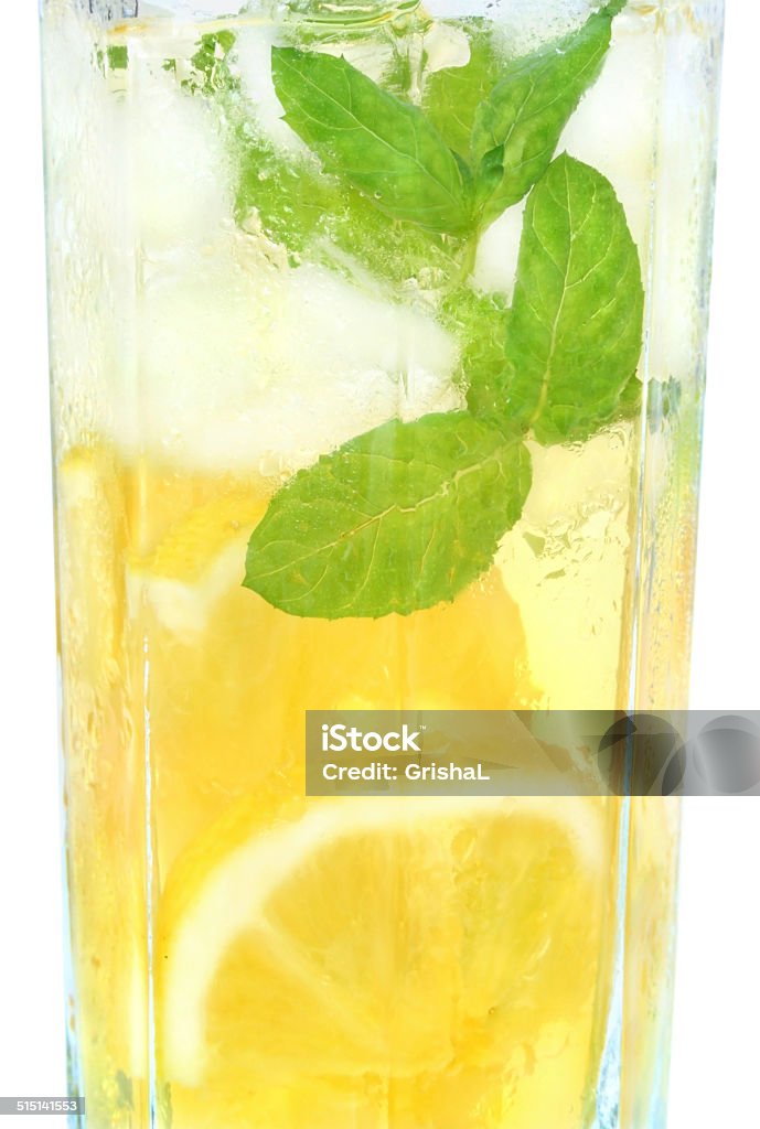 Fruit lemonade with ice cubes. Fruit lemonade in a highball glass on a white background. Cocktail Stock Photo