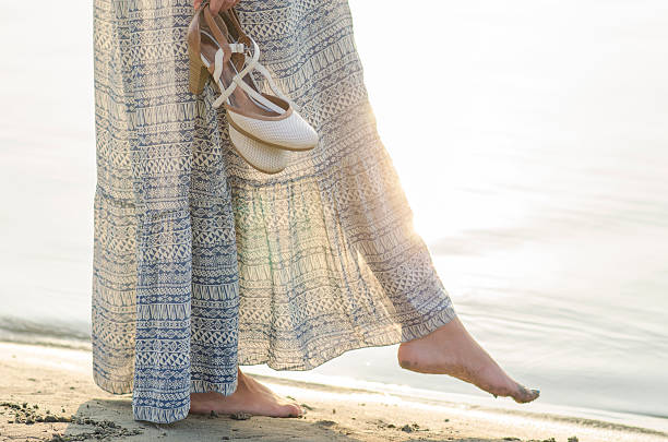 istock Woman walking at the beach and playing with water 515142399
