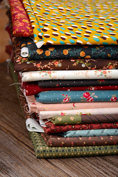 istock heap of cloth fabrics on wooden table 515143235