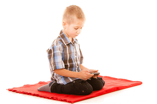istock Little boy playing games on smartphone 515144037