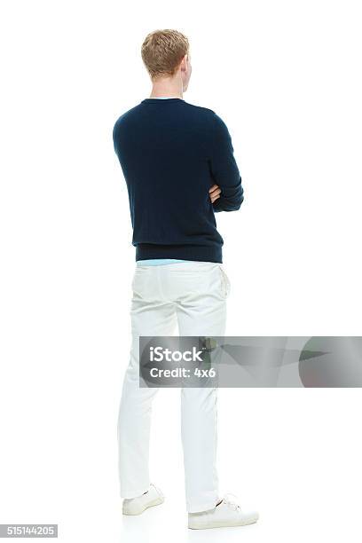 Rear View Of Casual Man Standing With Arms Crossed Stock Photo - Download Image Now - 20-29 Years, 25-29 Years, Adult