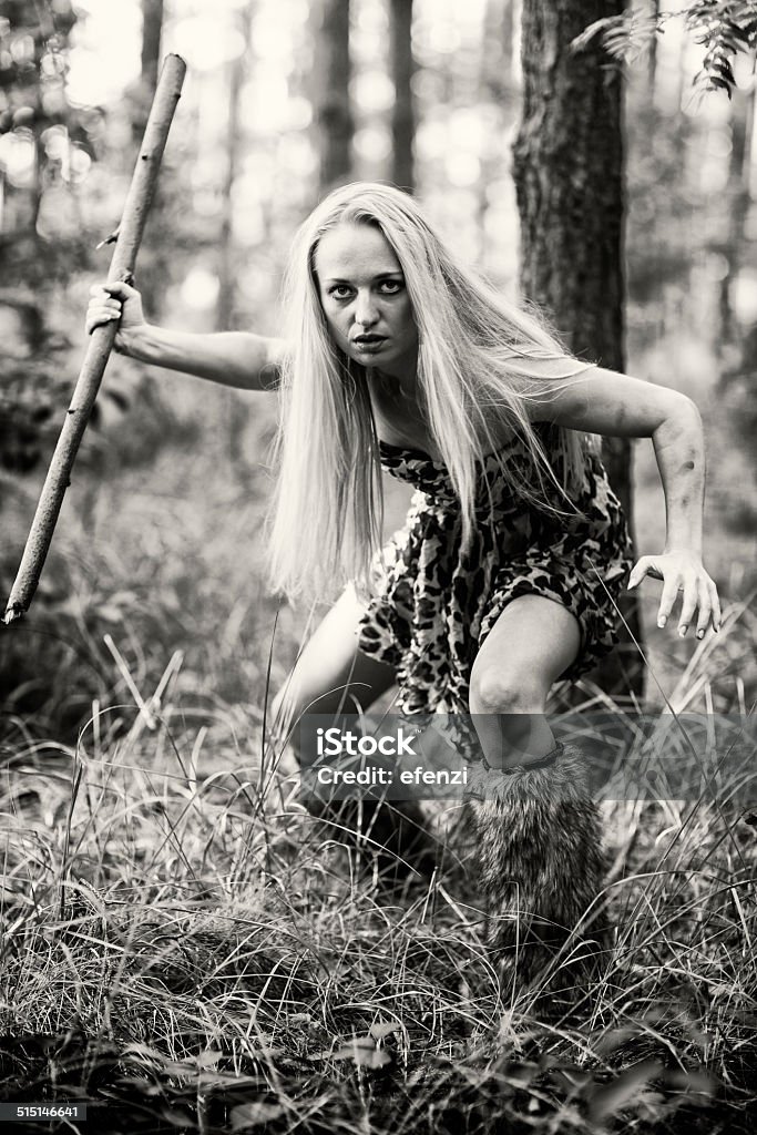 Barbarian Woman In Forest Barbarian woman creeping through the forest. Australopithecus Stock Photo