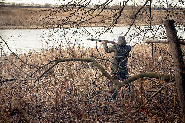 istock Hunter man with gun aiming and prepared to make shot 515146822