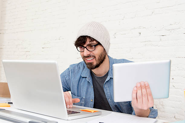 istock young hispanic attractive hipster businessman working with digital tablet pad 515147114