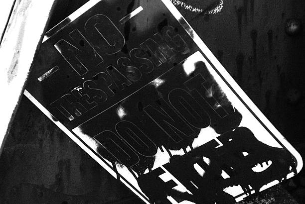 istock No trespassing sign graffiti spray painted B&W 515150282