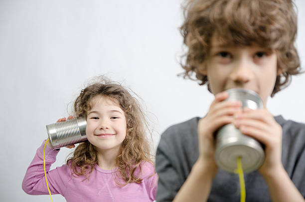 istock Boy and girl communicating through tin can phone 515151424