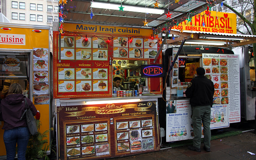 Portland, United States - January 16, 2016: 3 food carts, including Mawj Iraqi Cuisine. This photo includes their customers and was taken in downtown Portland. 