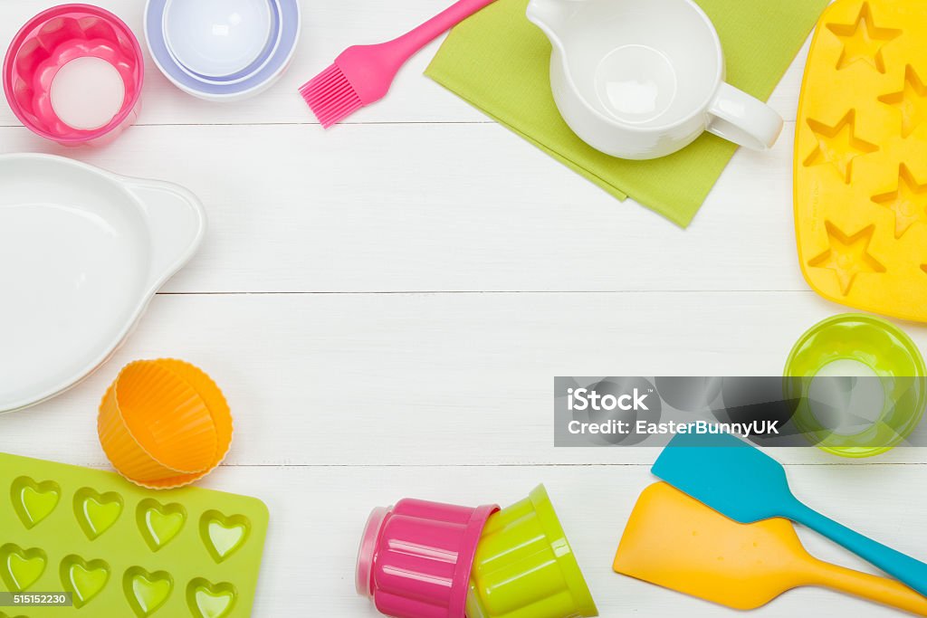 Bakery And Cooking Tools. Silicone Moulds, Cupcake Cases. Measur Bakery And Cooking Tools. Silicone Moulds, Cupcake Cases. Measuring Cups. Top View. White Wooden Table. Silicone Stock Photo