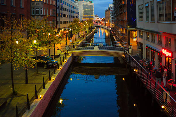 Aarhus, Denmark - September 28, 2010: Canal and houses, locals and visitors in downtown Aarhus, Denmark