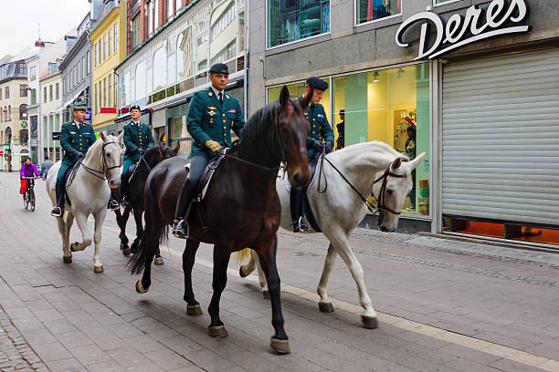 Copenhagen, Denmark - October 2, 2010: Street scene in the old city, with riding policemen, locals and visitors, in Copenhagen, Denmark