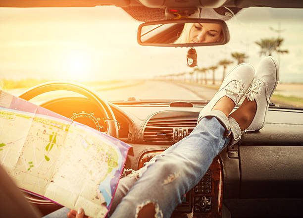 istock Young woman alone car traveler with map 515154600