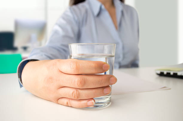 istock businesswoman drinking water at office 515154740