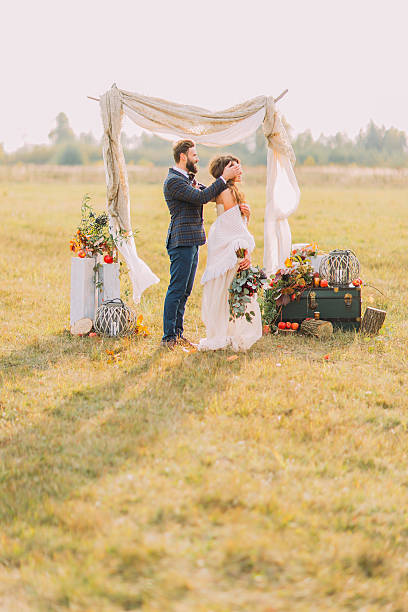 istock Handsome groom close eyes to his bride on wedding ceremony 515154752