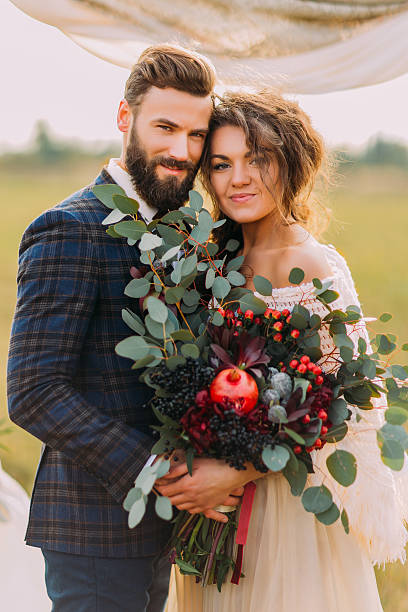 istock Charming newlyweds hold hands and smiling during the wedding ceremony 515154896