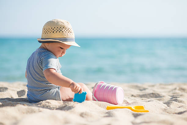 istock Cute baby boy playing with beach toys 515156266