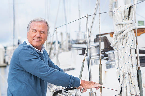 istock Senior man at marina, standing next to his yacht 515158262