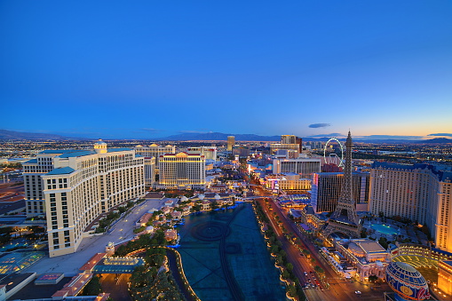 Las Vegas, USA - May 23, 2022: panoramic view of the Venetian Hotel and other famous hotels and casino with palm trees in front at the strip.