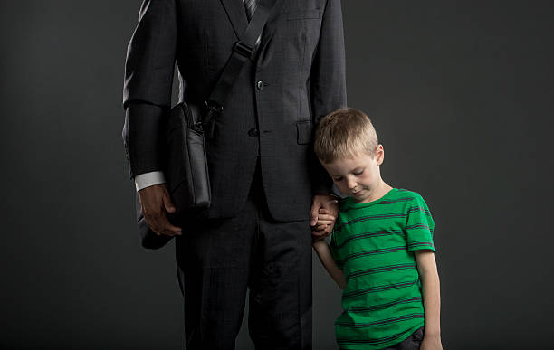 istock Sad Boy Holding on to His Father's Arm 515161620