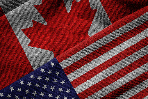 3D rendering of the flags of USA and Canada on woven fabric texture. Detailed textile pattern and grunge theme.