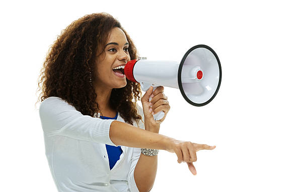 istock Smiling woman shouting with megaphone 515170119