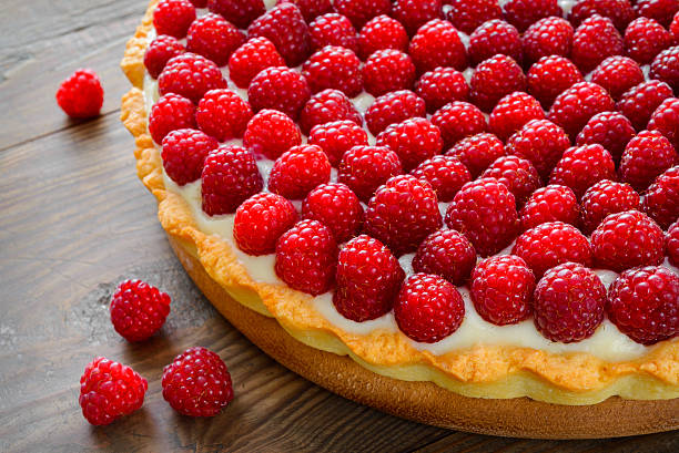 istock Delicious raspberry tarts on a wooden board 515170323