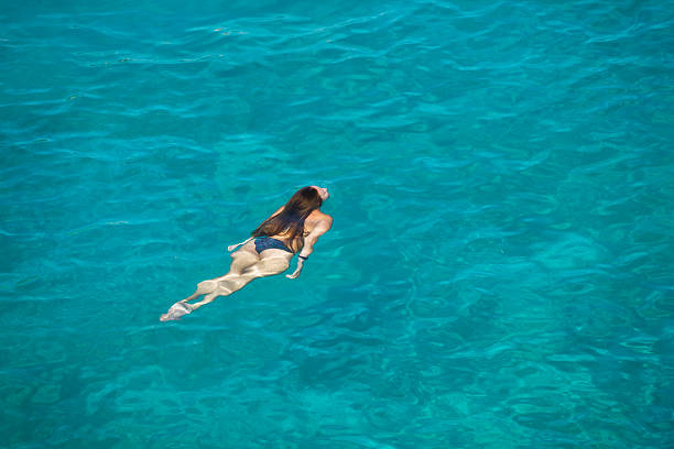 Young woman is diving at Stephano's bay on Crete. Turquoise water. Summer. XXXL (Canon Eos 1Ds Mark III)