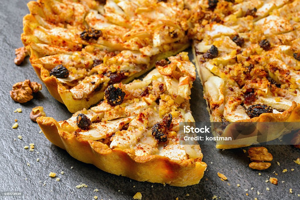 apple tart pie with nuts and raisins Closeup apple pie with nuts and raisins on wooden background Apple Pie Stock Photo