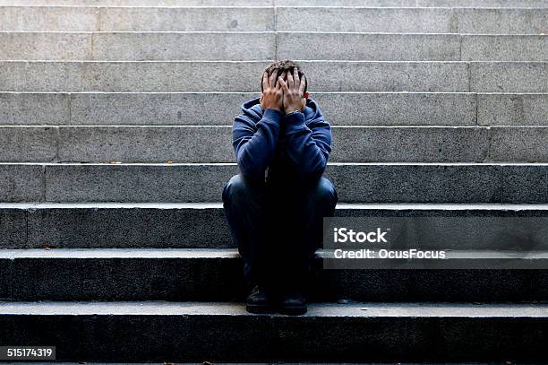 Young Man Suffering Depression Sitting On Ground Street Concrete Stairs Stock Photo - Download Image Now