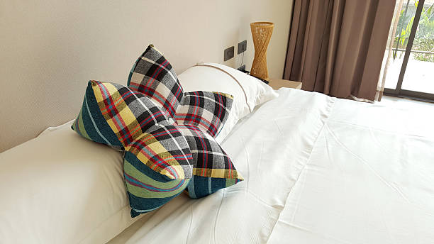 istock flower shape pliad pillow on white bed sheet 515185918