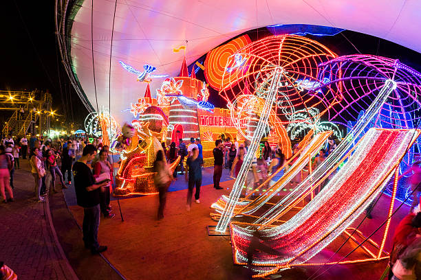 Medellin, Colombia - January 1, 2015: People walking around giant illuminated ornaments, part of the widely popular, annual Christmas light show or EDM Lights in Medellin, Colombia.