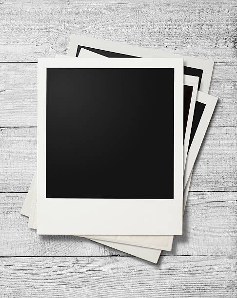 istock Polaroid photo frames on white wooden background 515189508