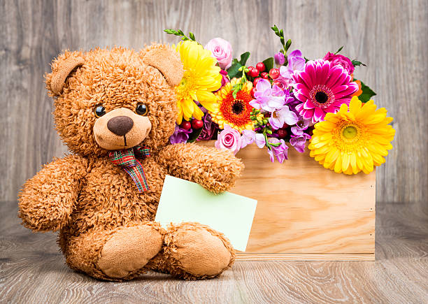 istock Bunch of flowers and a teddy bear 515191110
