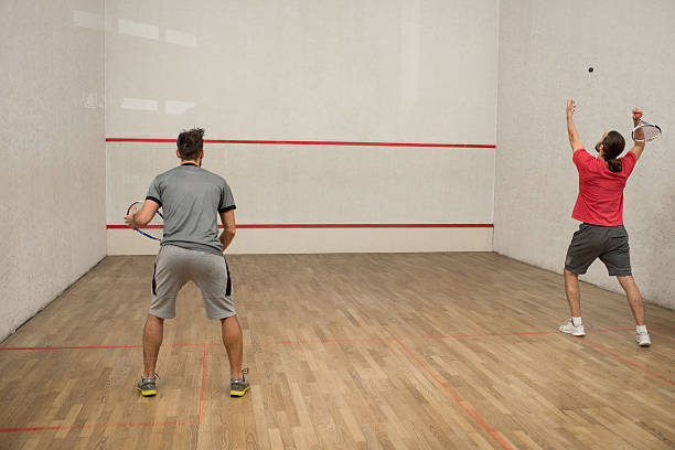 istock Back view of men playing squash on a court. 515191642