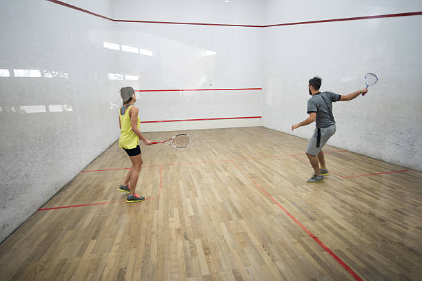 istock Back view of athletes playing racketball on a court. 515192568
