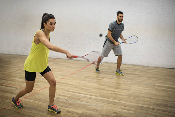 istock Young friends playing squash together on a court. 515193772