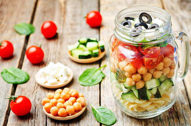 istock Pasta chickpeas cucumber tomatoes spinach goat cheese salad 515196420