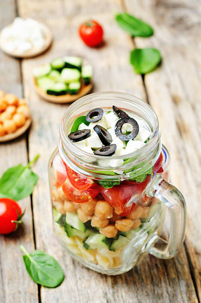 istock Pasta chickpeas cucumber tomatoes spinach goat cheese salad 515196438