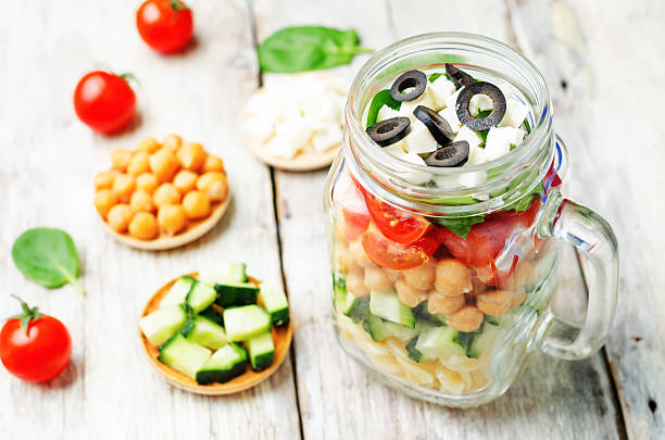 istock Pasta chickpeas cucumber tomatoes spinach goat cheese salad 515196442